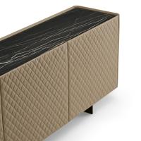 View of Maia sideboard with metal feet, top in Matt Portoro ceramic and doors covered in quilted leather