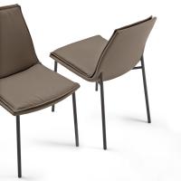 Front and side views of the Dalila padded chair with cushion and without armrests. Leather upholstery and metal legs in Charcoal-painted finish.