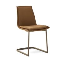 Dalila padded chair with cushion and without armrests. Leather upholstery and metal cantilever base in the Titanium finish.