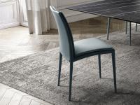 Chair with attached pillows entirely covered with teal leather
