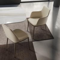 Michela upholstered chair, with and without armrests. Leather upholstery and painted metal legs in the Bronze finish.