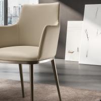 Close up of the Michela upholstered armchair. Leather upholstery and metal legs in the Bronze finish.