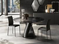 Rosa upholstered chairs with quilted backrest, paired with the Vortex table. Legs and seat fully-upholstered in leather. 