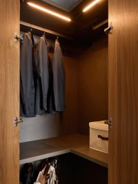 Pacific corner wardrobe equipped with central shelf, hanging rods and LED lights, for a perfectly functional corner niche