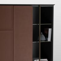 Apotema is a cupboard with frontal leather panels and a wooden structure with metal details and metal compartments