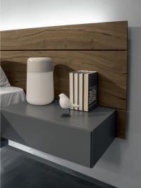 Close up of the one-drawer nightstand integrated into the wood panelling