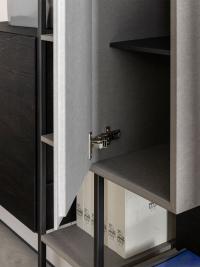 Detail of the hinged door of the wall unit: hinges adjustable in height, width and depth. Metal shelves not available, clear glass shelves will be supplied instead