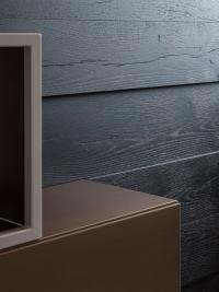 Elegant contrast between the metallic finishes and the material texture of the boiserie panels