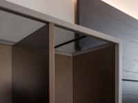 Open wall unit with metal frame, metal finish dividers and glass top