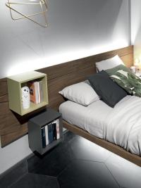 Combination of open elements in two colours contrasting the wooden headboard