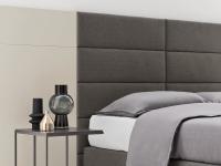Very high headboard layout. Soft shapes and geometric lines for an effect of elegant softness