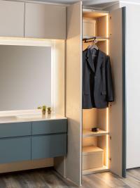 View of the inside of a Pacific column cupboard with shelves, pull-out clothes rails and internal LED lighting