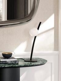 Ophelia glass blown bubble lamp in the table version, with a slender black painted metal frame resembling a flower stem.