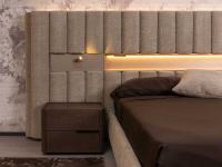 Detail of the platform bed with upholstered wall panelling, equipped with optional spotlight and illuminated open compartment