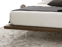 Detail of the slim bed-frame and the high transparent feet for an extra light effect