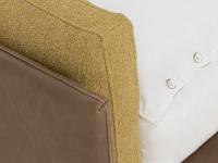 Detail of the headboard cushions with a bouclé fabric; cushions slightly protrude from the Tivano leather headboard