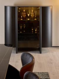 Daphne curved wooden buffet cabinet in a black oak blockboard finish with central glass door and Sahara Noir ceramic top