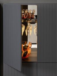 Interior view of the bar cabinet with smoked glass shelves, glass holder shelf, mirror on back and interior LED bars