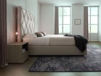 Side view of upholstered bed with quilted headboard Olivier
