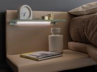 Detail of integrated bedside tables with glass shelf and LED light
