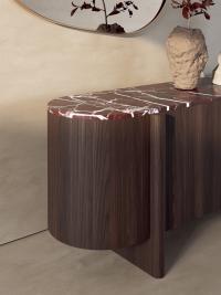 Detail of the Dafne sideboard in curved American walnut wood with Levanto red marble top