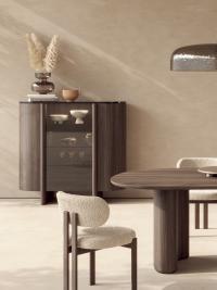 The Dafne buffet cabinet with an oak wood structure in the finish Moka, a central glass door and top in Marquinia marble