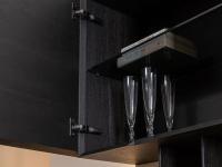 The inside of the wall unit is equipped with a practical shelf made from smoked glass