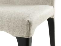 Close-up of the stitching on the corner of the Delma chair with solid wood legs