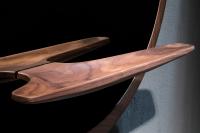 Curved and hollowed wooden shelf with natural veining