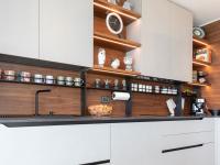 Kitchen splashback with cup and spice rack and hooks.