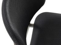 Detail of the curved backrest, upholstered and covered in faux leather