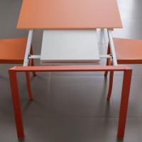 Main extending table with extensions in melamine stored under the table top