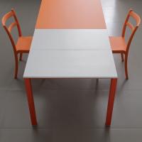 Main table has a top in glass and extensions available in white, canvas and grey melamine