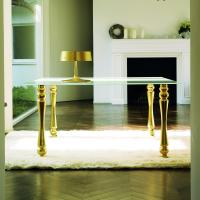Giove, customizable glass table, with frosted glass table top and Gold-leaf covered legs 