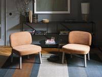 Hamide is a lounge low chair without armrests with ash-wood legs painted in Linen colour