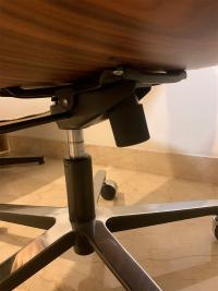 Detail of the lever and round know to adjust the height - inclination of the chair as adjust the rigidity of the back