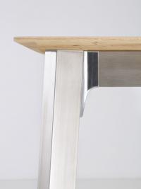 Detail of the metal leg in brushed stainless steel and the polished joining point