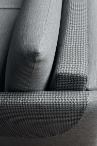 Detail of the different fabric patch on the armrest and backrest of the sofa bed 