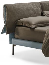 Detail of Ambra leather bed with cushions covering the headboard made of fabric and leather