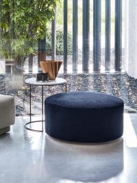 Heliodoro coffee table with an open metal base and combined with a low pouf
