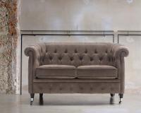 Isadora in the sofa model with 2 seater in tufted leather