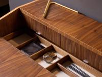 Detail of the concealed storage compartment with dividers in natural walnut to match the top and legs