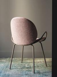 Athena upholstered chair with thin metal legs and armrests which widen outwards