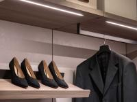 Close up of the slanted shoe-rack shelves with heel pad and linear shelves with LED lighting