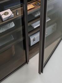 Doors in smoked clear glass with internal drawers and glass fronts