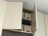Upper doors of the TV panel wardrobe - useful compartment with internal shelf
