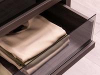 Smooth opening of spacious drawers with smoked glass fronts