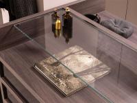Practical double countertop created by the wooden dresser and glass top
