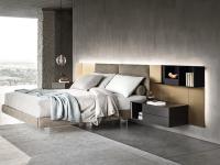 The california upholstered bed with upholstered panels, panels in metallic lacquer, and open shelving units in wood veneer