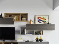 Modular shaped shelf with matte lacquered Cube back panel, combined with drop-down wall units with contrasting fronts